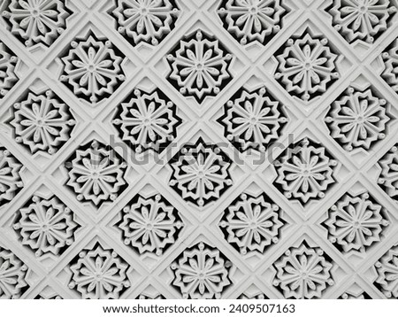 The white walls have openwork patterns of flowers.background and texture.brick block pattern