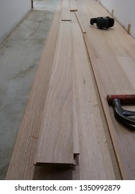 White Walls With Planks Of Australian Hardwood Shining Gum (Eucalyptus Nitens) Ready To Be Laid On A Concrete Slab As A Floating Floor In A Home Improvement Renovation In Victoria, Australia