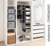White wardrobe with clothes, Shoe Rack Organizer and accessories. Modern interior design.