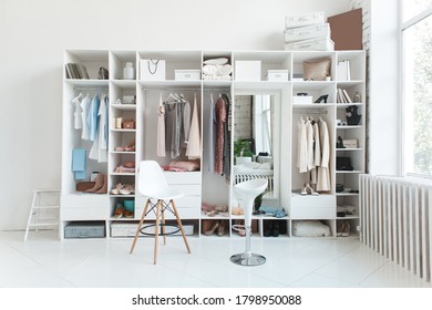 White wardrobe with stylish clothes on hangers - Shutterstock ID 1798950088