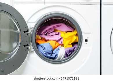 White Washing Machine With Open Door in a Laundry Room - Powered by Shutterstock