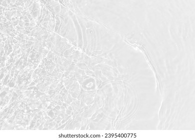 White water with ripples on the surface. Defocus blurred transparent white colored clear calm water surface texture with splashes and bubbles. Water waves with shining pattern texture background. - Powered by Shutterstock