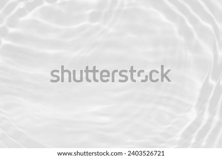 White water with ripples on the surface. Defocus blurred transparent white colored clear calm water surface texture with splashes and bubbles. Water.