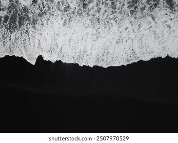 White waves on a black sand beach in a volcanic island in Iceland from a drone view - Powered by Shutterstock