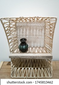 White Weaving Shelf Made From Recycled Basket And Old Wooden Plank. Upcycling, Sustainablity, Environmental Concept.