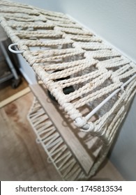 White Weaving Shelf Made From Recycled Basket And Old Wooden Plank. Upcycling, Sustainablity, Environmental Concept.