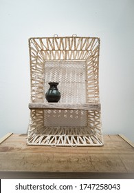 White Weaving Shelf Made From Recycled Basket And Old Wooden Plank. Upcycling, Sustainablity, Environmental Concept.