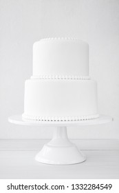 White Wedding Cake Blank On A White Background. Simple Minimalism.