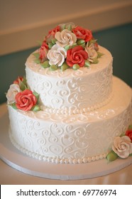 White Wedding Cake With Orange And Green Flowers