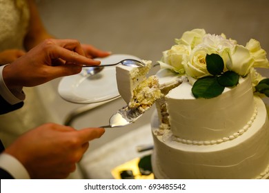 White wedding cake with real roses decorations