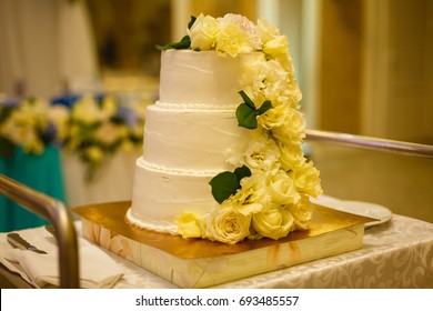 White wedding cake with real roses decorations