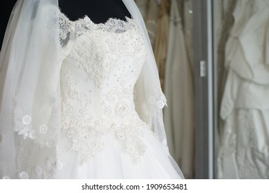 White Wedding Dress Gown On Black Mannequin. Bride's Morning Wedding Preparation Concept