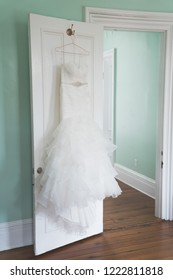 White Wedding Dress Hanging In Bridal Suite