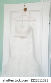 White Wedding Dress Hanging In Bridal Suite