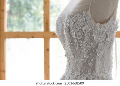 White wedding dress on a mannequin doll in studio.A wedding dress or bridal gown is the dress worn by the bride during a wedding ceremony.