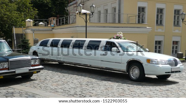 white wedding\
limousine  at day on\
street