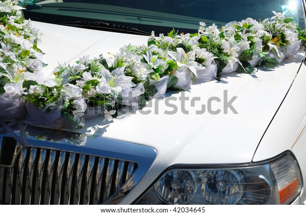 White wedding\
limousine decorated with\
flowers