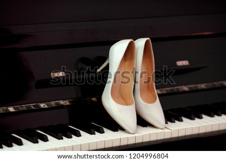 White wedding shoes of bride in piano