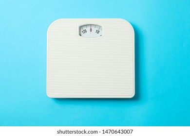 White Weigh Scales On Blue Background, Top View