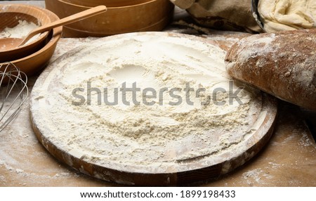 Similar – Image, Stock Photo baked round white wheat bread on a textile towel