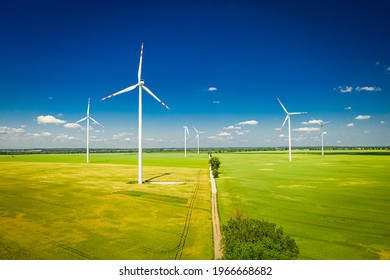 White Wind Turbine On Green Field. Wind Farm In Poland. Green And Renewable Energy.