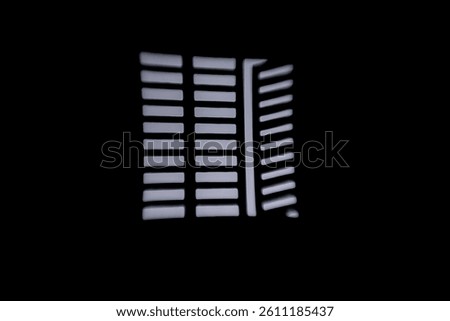 White window slats with a reflection on a black wall an ideal background