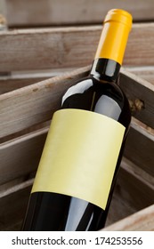 White Wine Bottle With Empty Label In Wooden Crate