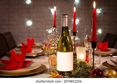 White Wine Bottle On A Christmas Holiday Festive Party Table With Wine A Glass On Red And Gold Shiny Decoration