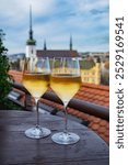 white wine by the glass, in a rooftop cafe, with the city of Brno, Czech Republic in the background