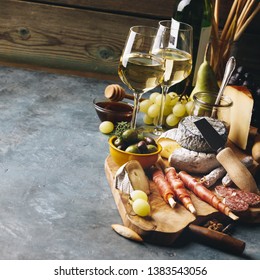 White wine with charcuterie assortment on the stone background - Powered by Shutterstock