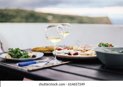 White wine, cheese plate. Dinner on sunset with amazing view on mountain Pico, Azores, Portugal, Europe