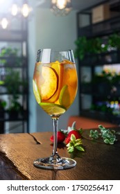 White Wine Cocktail With Slices Of Peach Lime And Orange