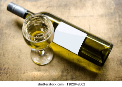 White Wine In Glass And Bottle On Golden Rustic Table