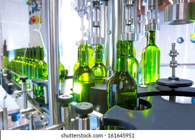 White Wine In Glass Bottling Machine At Winery