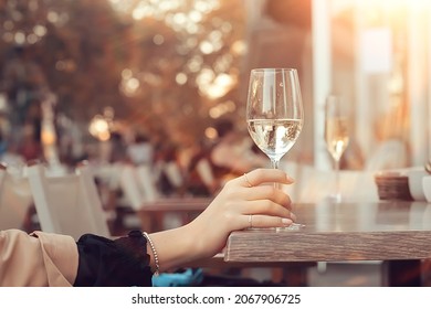 White Wine Glass In An Outdoor Cafe, Spring View In A Restaurant