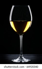 White Wine Glass Silhouette Over Black Background