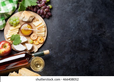 White Wine, Grape, Cheese And Honey Over Stone Table. Top View With Copy Space