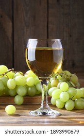 White Wine With Grapes On A Wooden Table