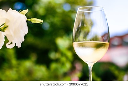 White Wine In Luxury Restaurant On Summer Garden Terrace, Wine Tasting Experience At Winery In The Vineyard, Gourmet Tour And Holiday Travel.