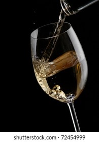 White Wine Pour In A Glass On Black Background