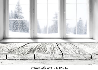 white winter window with a wooden table and a place for an advertising product