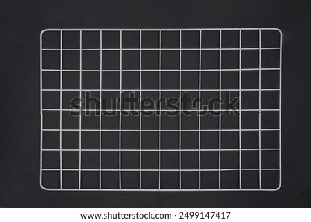 White wire grid wall on black background isolated
