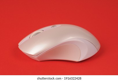 White Wireless Computer Mouse Side View On Red Background