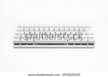 White, wireless gaming mechanical computer keyboard closeup. Minimal, modern design on white background. Side view. 60 percent keyboard. copy space. Communication device. Cyberspace and data.