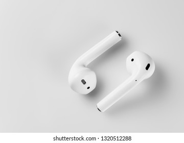 White wireless headphones are on a white background. Macro.