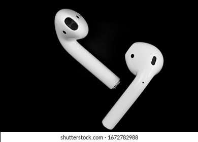 white wireless headphones on a black background. macro