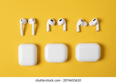 white wireless headphones on yellow background