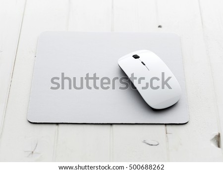 White wireless mouse on a mouse pad