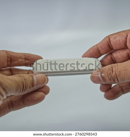 White wireless USB dongle device for mobile broadband internet access on computers and laptops