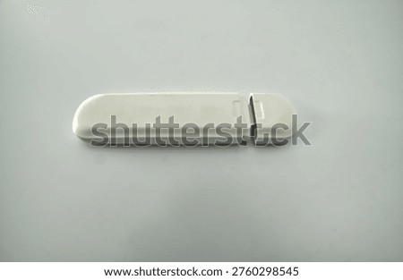 White wireless USB dongle device for mobile broadband internet access on computers and laptops
